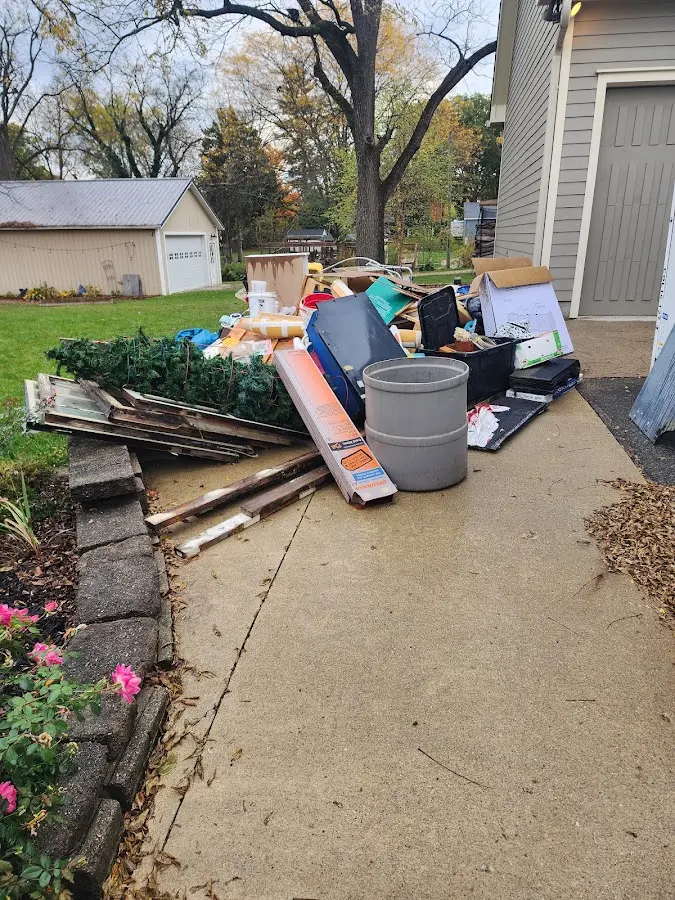 Dumpster being loaded with debris for Residential Dumpster Rental in Chelan